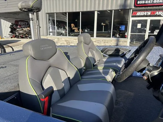 Slide: The Image of 2019 Skeeter ZX250 boat interior with gray and green seats, steering wheel visible. - 7