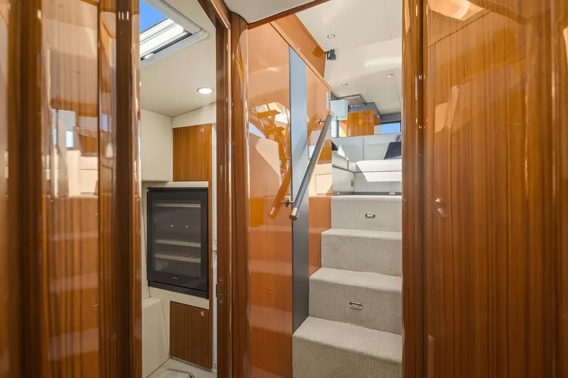 Slide: The Image of Interior of 2016 Maritimo M50 yacht with wooden finishes and carpeted stairs. - 26