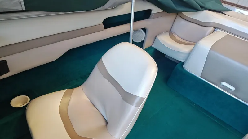 Slide: The Image of Interior of a 1994 Chris-Craft 197 boat with beige and teal seating. - 5