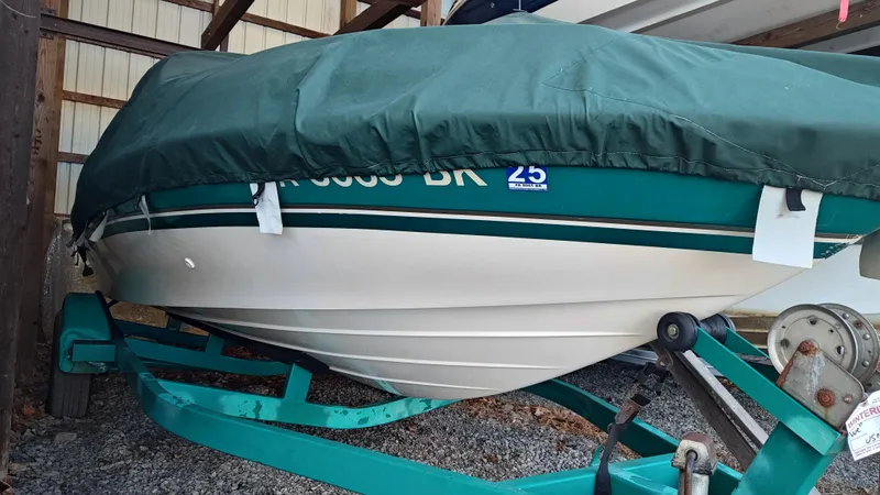 Slide: The Image of 1994 Chris-Craft 197 boat covered and stored on a trailer in a shed. - 7