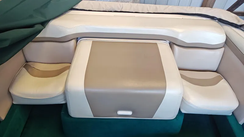 Slide: The Image of 1994 Chris-Craft 197 boat interior seating with beige and white upholstery. - 9