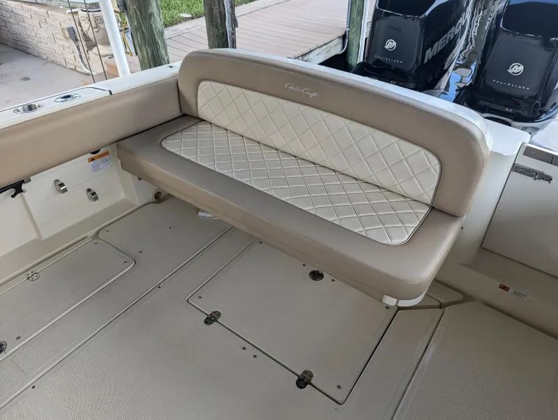 Slide: The Image of 2015 Chris-Craft Catalina 29 boat interior with cushioned seating and storage compartments. - 11