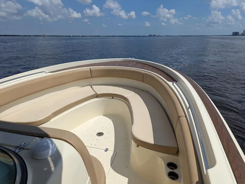 Slide: The Image of 2015 Chris-Craft Catalina 29 boat on calm water under a blue sky. - 12