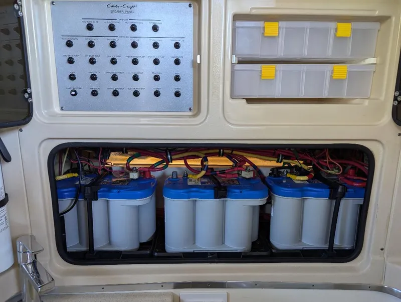 Slide: The Image of 2015 Chris-Craft Catalina 29 battery compartment with control panel and storage boxes. - 15