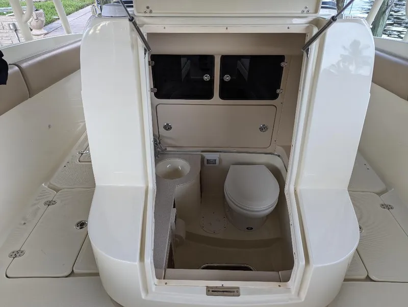 Slide: The Image of 2015 Chris-Craft Catalina 29 boat interior with compact bathroom and toilet. - 18