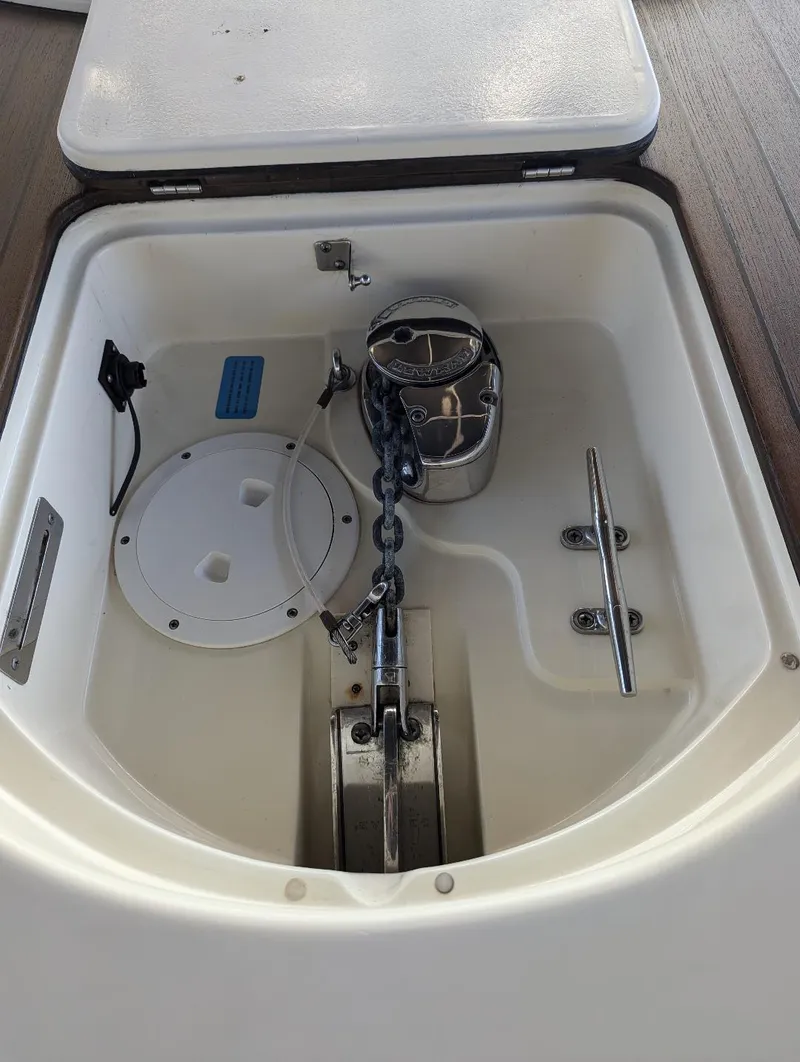 Slide: The Image of Anchor compartment of 2015 Chris-Craft Catalina 29 with chain and winch. - 22