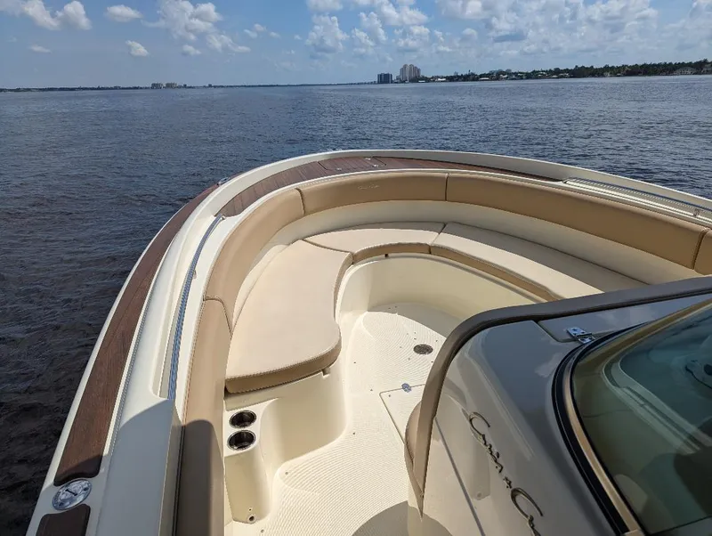 Slide: The Image of 2015 Chris-Craft Catalina 29 boat on calm water under a partly cloudy sky. - 23