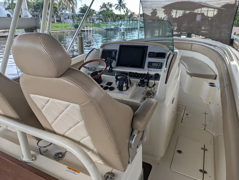 Slide: The Image of 2015 Chris-Craft Catalina 29 boat interior with helm, steering wheel, and navigation equipment. - 24