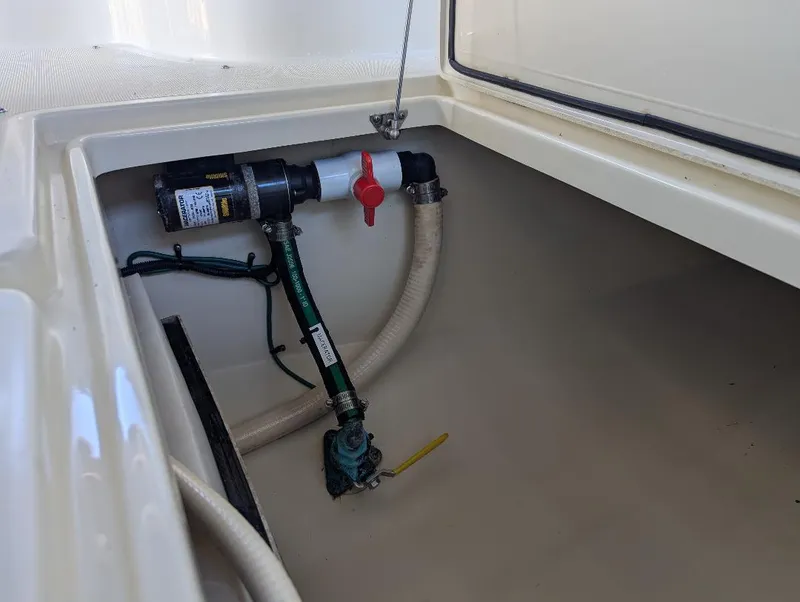 Slide: The Image of 2015 Chris-Craft Catalina 29 boat compartment with plumbing and valve system. - 25