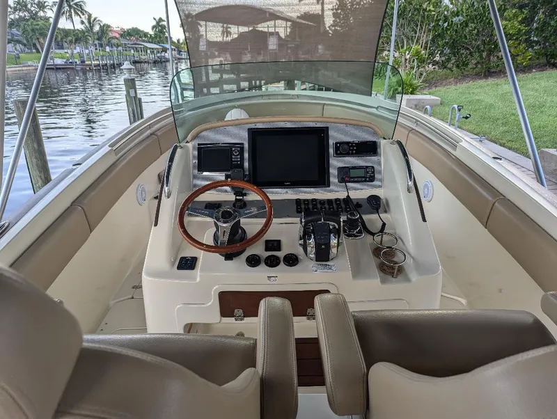 Slide: The Image of 2015 Chris-Craft Catalina 29 helm with steering wheel, controls, and navigation equipment. - 26