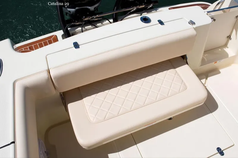 Slide: The Image of 2015 Chris-Craft Catalina 29 boat with elegant seating and wooden deck on open water. - 5
