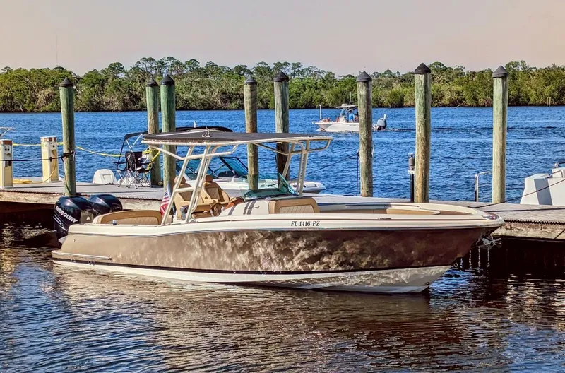 Slide: The Image of 2015 Chris-Craft Catalina 29 boat docked by a serene waterfront. - 7