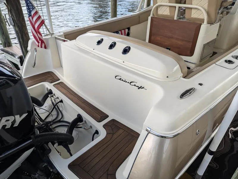 Slide: The Image of 2015 Chris-Craft Catalina 29 boat with Mercury engine, docked by the water. - 9