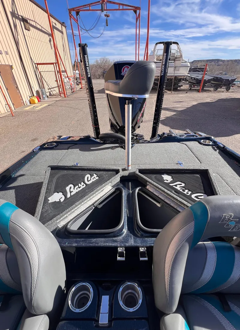 Slide: The Image of 2021 Bass Cat Caracal boat interior with seating and storage compartments. - 5