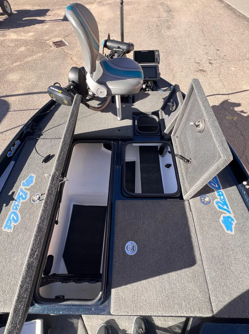 Slide: The Image of 2021 Bass Cat Caracal boat interior with open storage compartments and seating. - 8