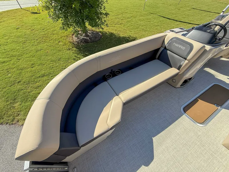 Slide: The Image of 2025 Harris Cruiser 250 CWDH with beige seating on green lawn. - 10