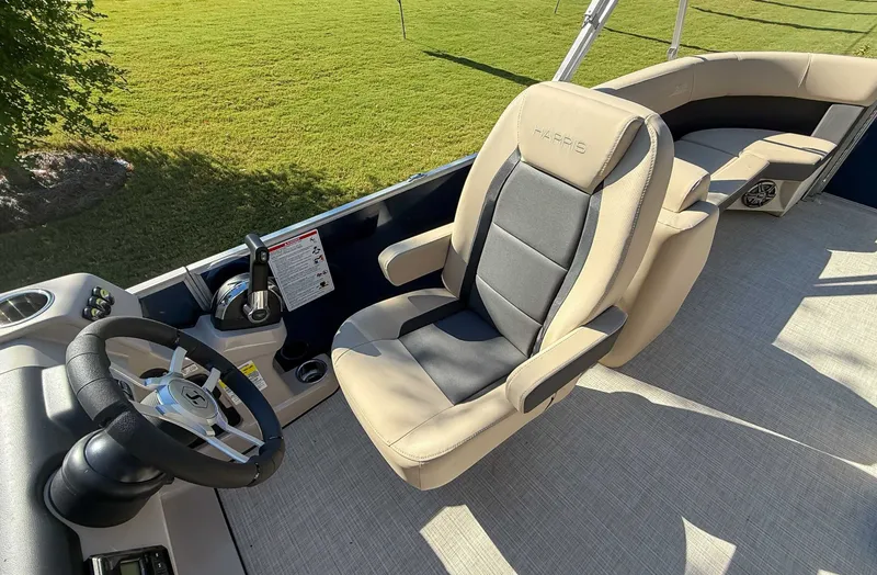 Slide: The Image of Interior of 2025 Harris Cruiser 250 CWDH with steering wheel and seat. - 13