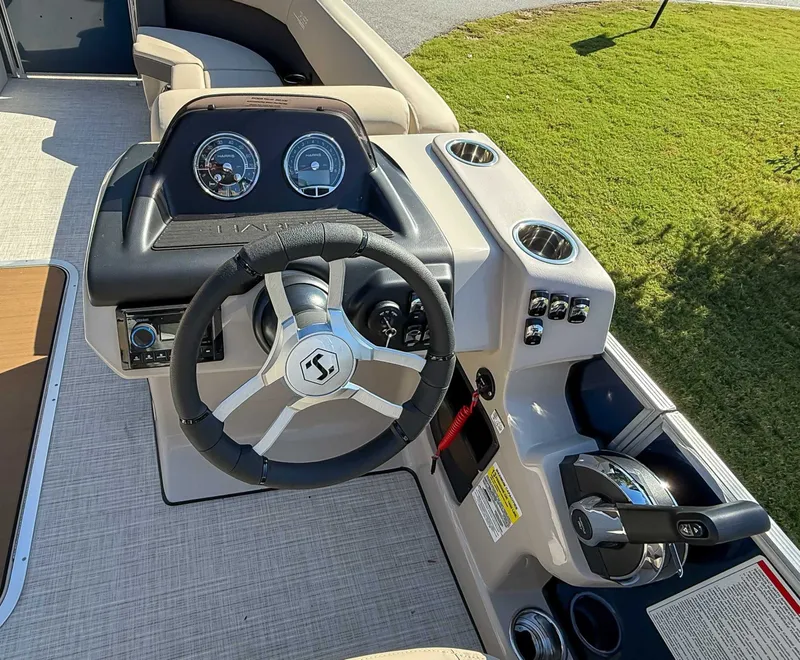 Slide: The Image of 2025 Harris Cruiser 250 CWDH boat dashboard and steering wheel. - 14
