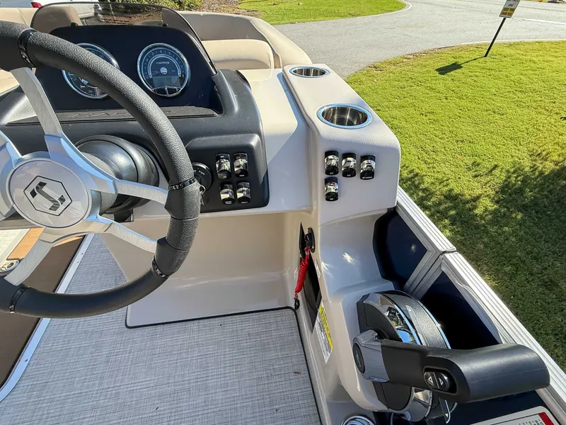 Slide: The Image of 2025 Harris Cruiser 250 CWDH helm with steering wheel and controls. - 15