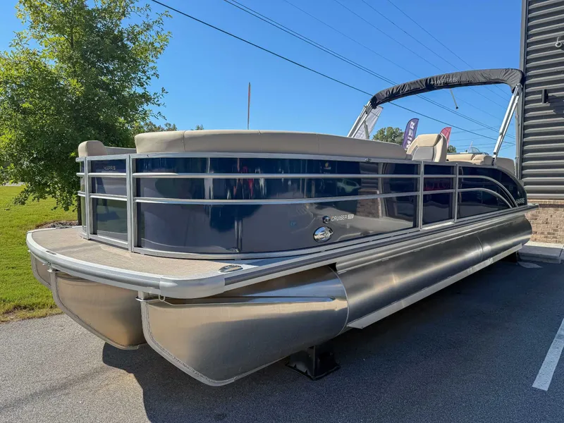 Slide: The Image of 2025 Harris Cruiser 250 CWDH pontoon boat on parking lot. - 3