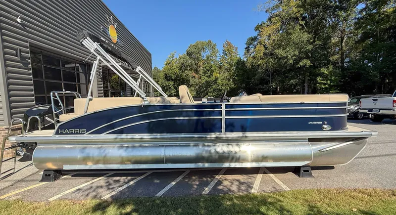 Slide: The Image of Harris Cruiser 250 CWDH 2025 pontoon boat parked outside a building. - 6