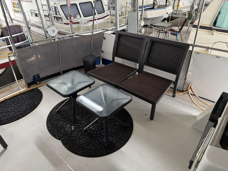 Slide: The Image of 1988 Chris-Craft 426 Catalina deck with chairs and tables, surrounded by other boats. - 10