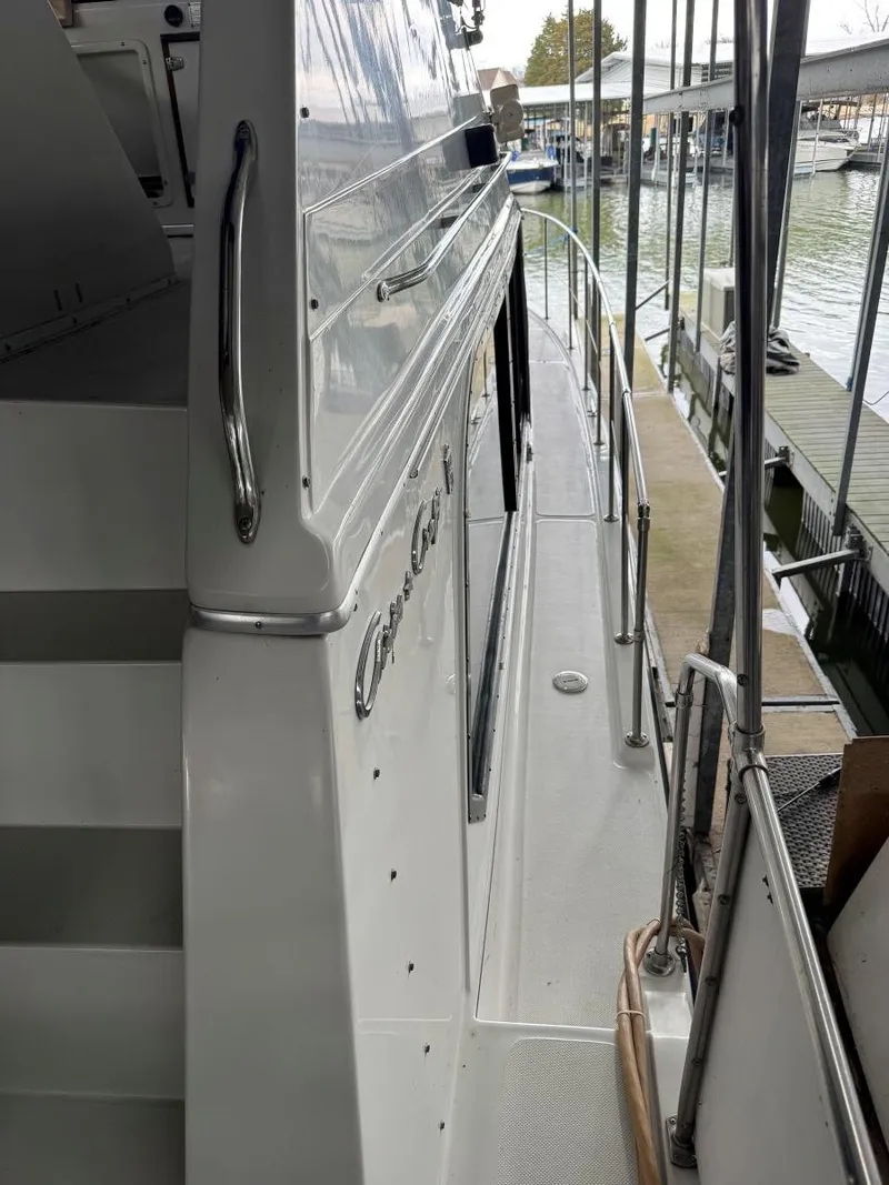 Slide: The Image of 1988 Chris-Craft 426 Catalina yacht docked at marina, side view with railing and stairs. - 11