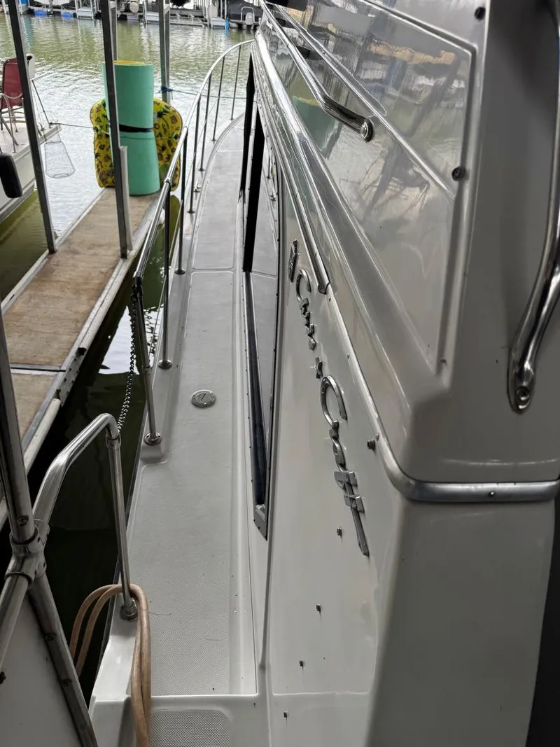 Slide: The Image of 1988 Chris-Craft 426 Catalina yacht docked, showcasing sleek side view and polished exterior. - 12