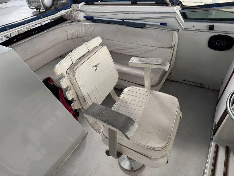 Slide: The Image of 1988 Chris-Craft 426 Catalina boat interior with white seating and helm chair. - 14
