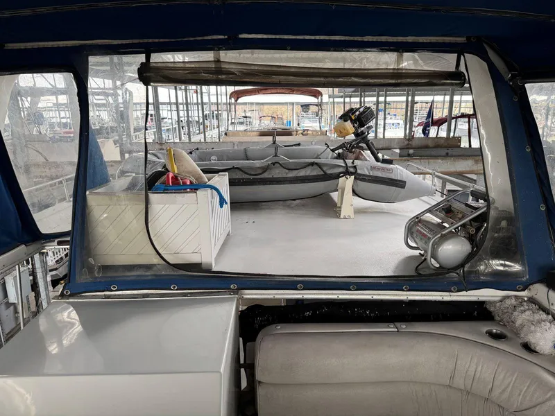 Slide: The Image of 1988 Chris-Craft 426 Catalina boat interior with seating and equipment, docked in a marina. - 16