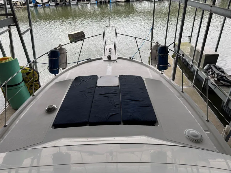 Slide: The Image of 1988 Chris-Craft 426 Catalina yacht docked, featuring spacious deck with cushions. - 18