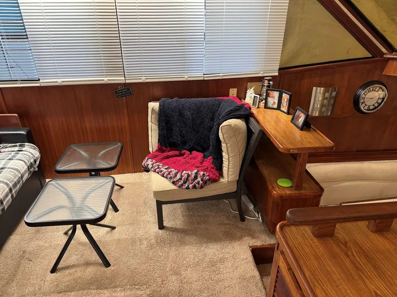 Slide: The Image of 1988 Chris-Craft 426 Catalina interior with cozy seating, tables, and decor. - 21