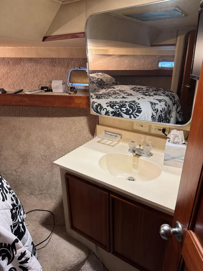 Slide: The Image of 1988 Chris-Craft 426 Catalina yacht interior with sink, mirror, and bed. - 31