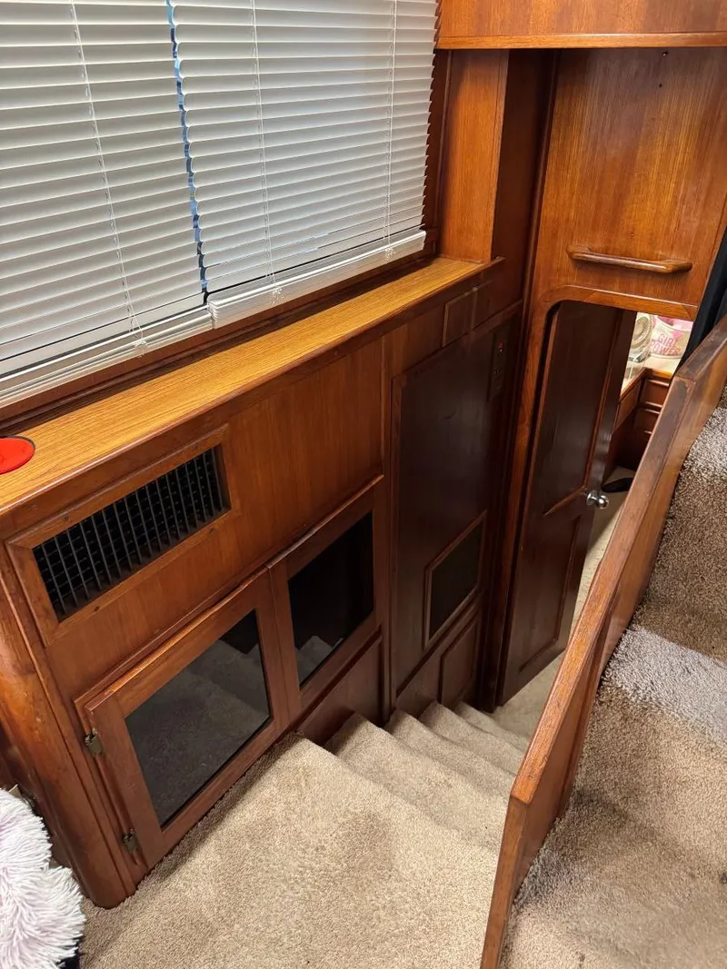 Slide: The Image of 1988 Chris-Craft 426 Catalina interior with wooden stairs and cabinetry. - 36
