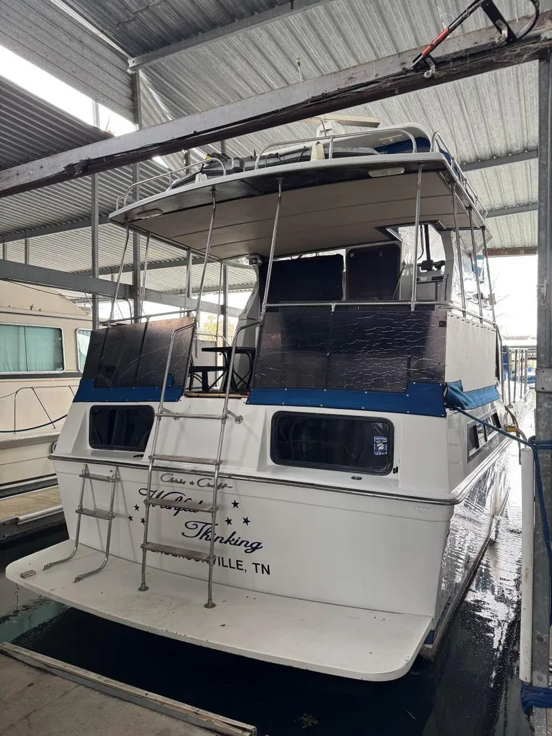 Slide: The Image of 1988 Chris-Craft 426 Catalina yacht docked in a covered marina. - 4