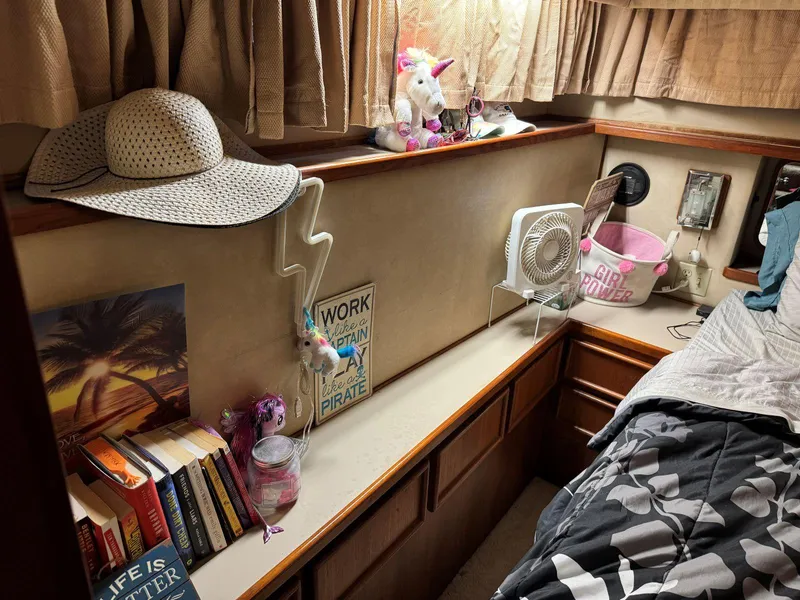 Slide: The Image of Cozy cabin interior of 1988 Chris-Craft 426 Catalina with books, fan, and decor. - 43