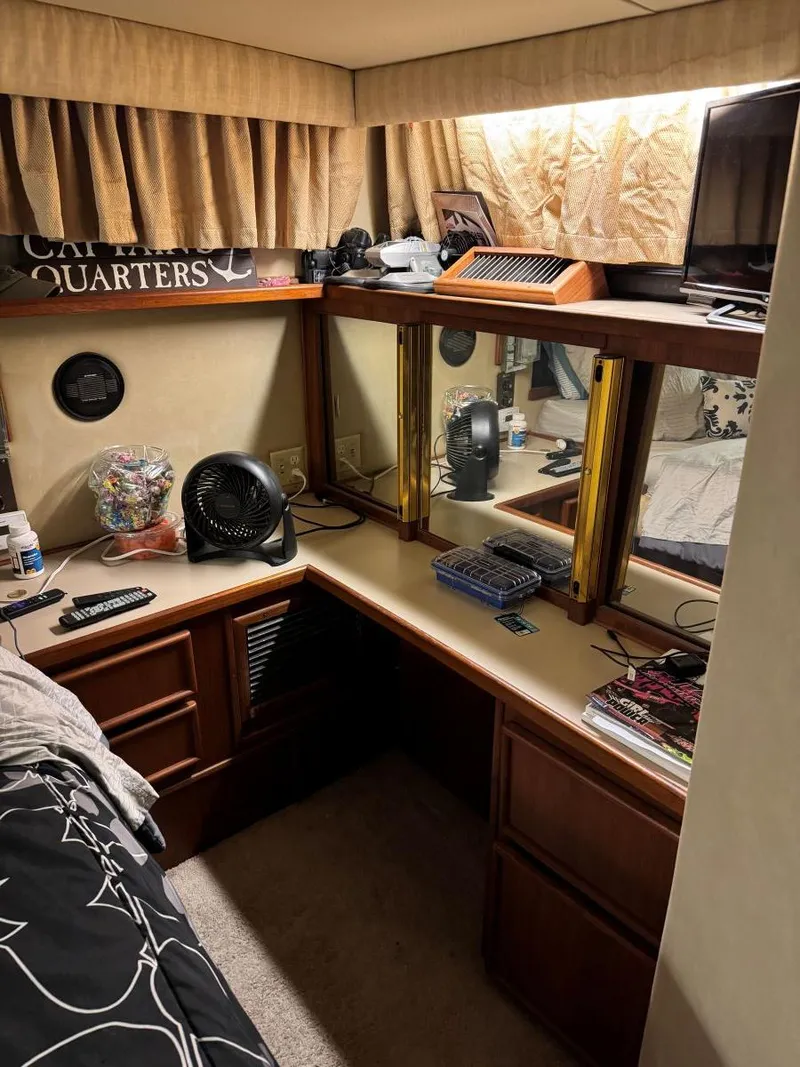 Slide: The Image of 1988 Chris-Craft 426 Catalina cabin interior with desk, fan, and decor. - 44
