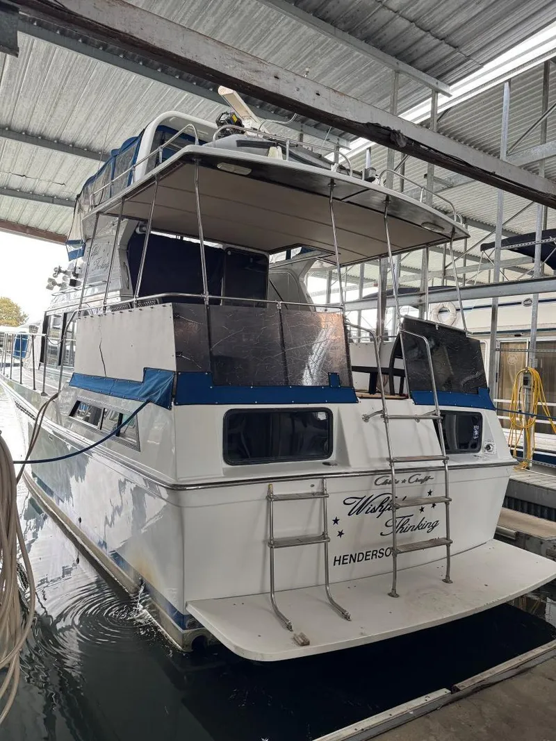 Slide: The Image of 1988 Chris-Craft 426 Catalina yacht docked in a covered marina. - 5