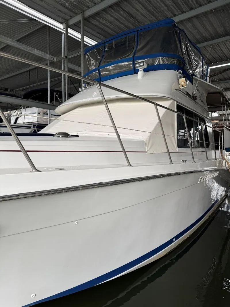 Slide: The Image of 1988 Chris-Craft 426 Catalina yacht docked in a covered marina. - 6