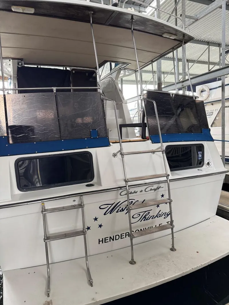 Slide: The Image of 1988 Chris-Craft 426 Catalina boat docked, featuring rear ladder and "Wishful Thinking" name. - 7