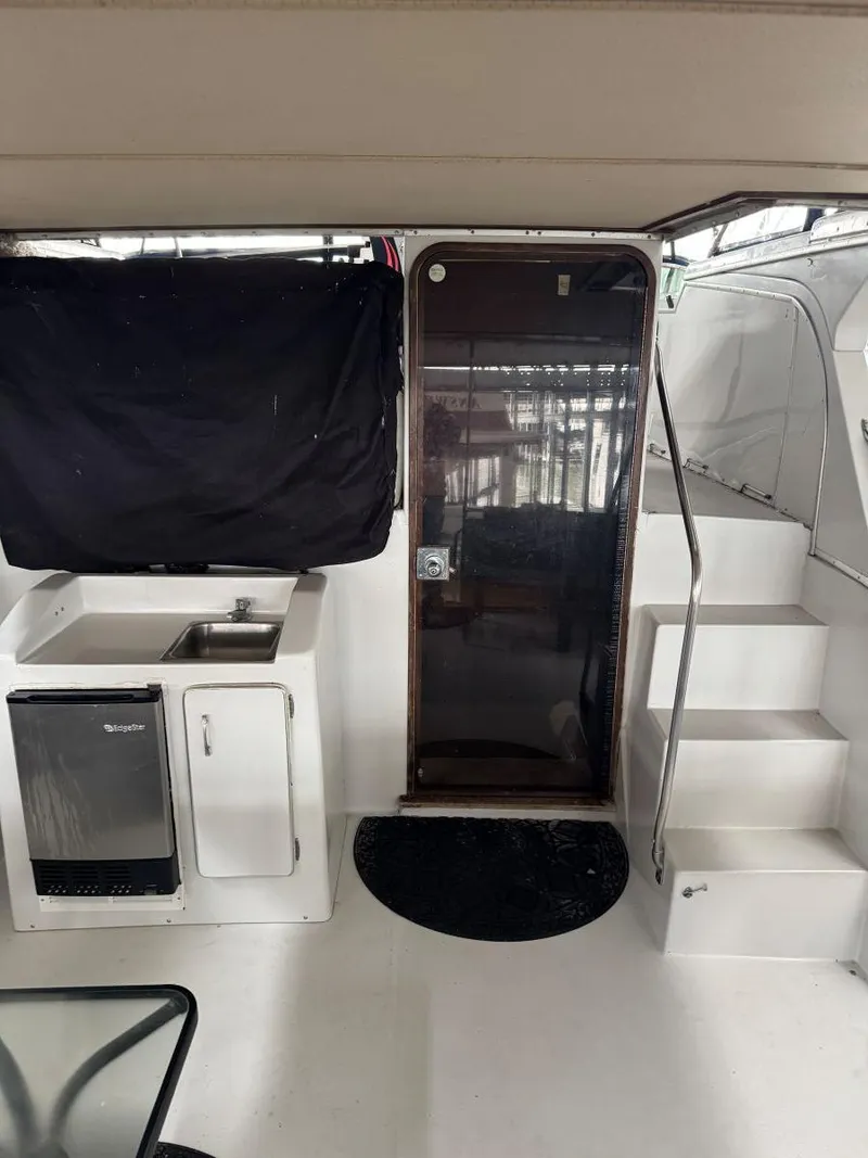 Slide: The Image of 1988 Chris-Craft 426 Catalina interior with kitchenette, stairs, and door. - 8