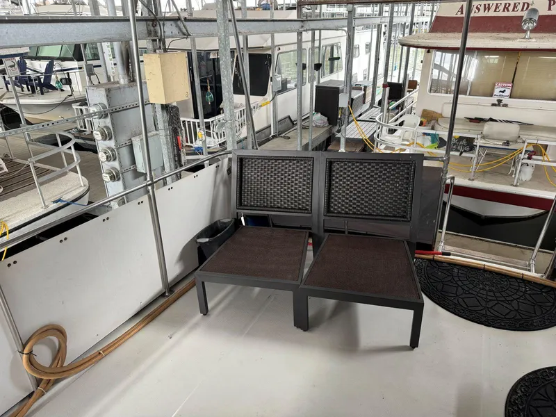 Slide: The Image of Outdoor seating on 1988 Chris-Craft 426 Catalina yacht deck, surrounded by marina. - 9