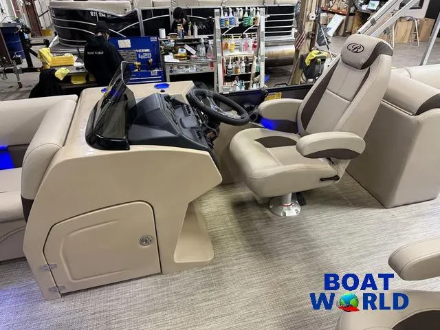Slide: The Image of 2025 Bentley Pontoons Legacy 223 Navigator Tritoon interior with captain's chair and console. - 11