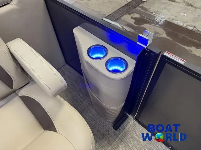 Slide: The Image of 2025 Bentley Pontoons Legacy 223 Navigator interior with illuminated cup holders and beige seating. - 23