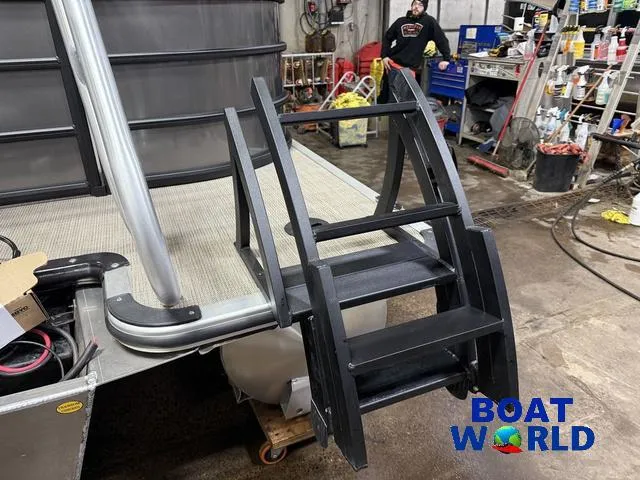 Slide: The Image of 2025 Bentley Pontoons Legacy 223 Navigator Tritoon in workshop with ladder, Boat World logo. - 44