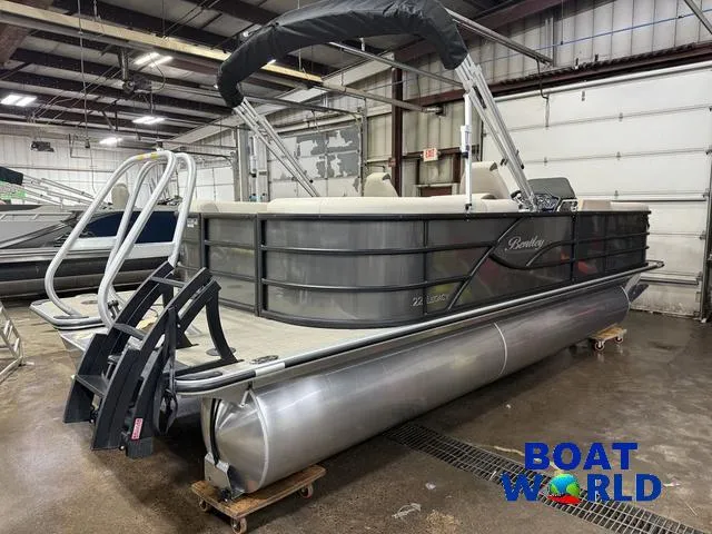 Slide: The Image of 2025 Bentley Pontoons Legacy 223 Navigator Quad Lounge Tritoon in showroom, featuring Honda 4 engine. - 46