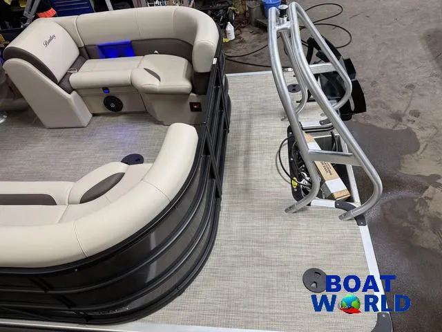 Slide: The Image of 2025 Bentley Pontoons Legacy 223 Navigator Quad Lounge Tritoon interior with beige seating, Boat World logo. - 6
