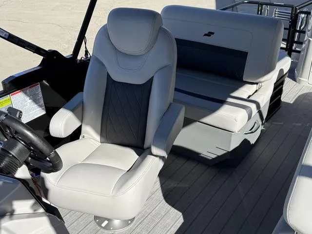 Slide: The Image of 2025 Starcraft CX 23 RL boat console with cup holders and storage compartment. - 14
