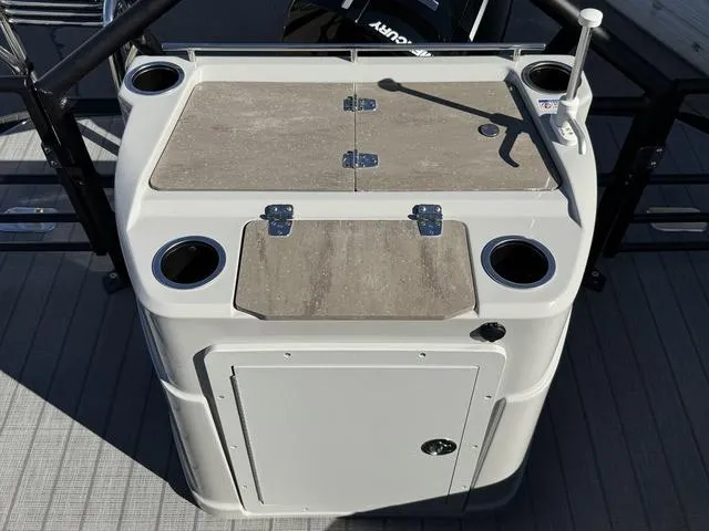 Slide: The Image of 2025 Starcraft CX 23 RL boat console with cup holders and storage compartments. - 18