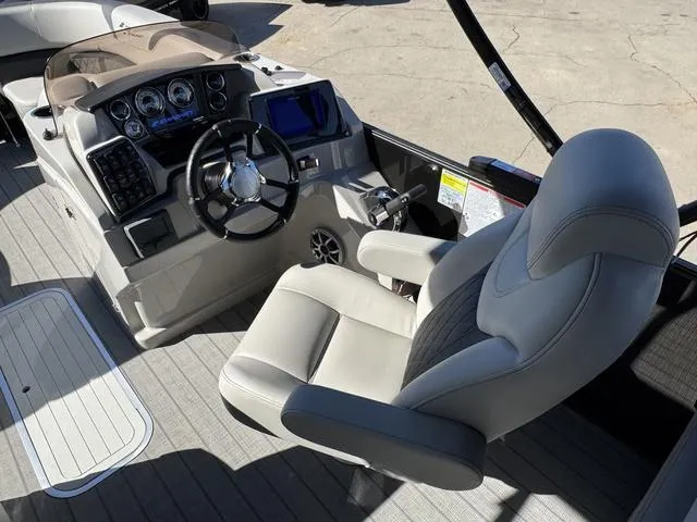 Slide: The Image of Captain's seat and dashboard of 2025 Starcraft CX 23 RL boat, featuring modern controls. - 21